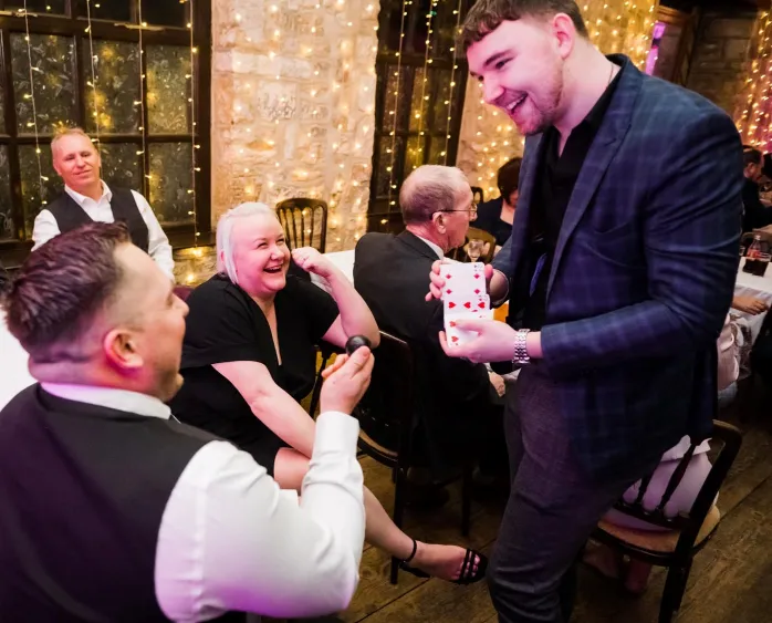 Jordan Maycock magician performs a card trick