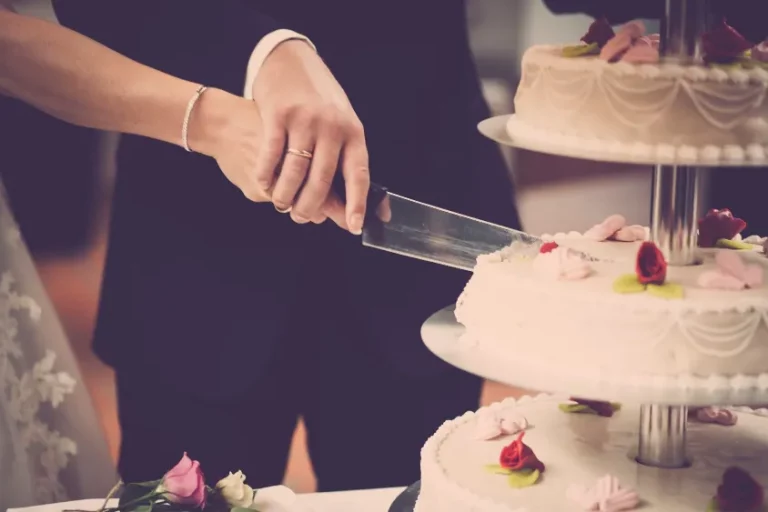 A couple cutting a wedding cake